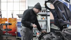 A technician performing a brake fluid flush on a vehicle
