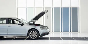 Performing a parasitic drain test on a car battery with a multimeter.