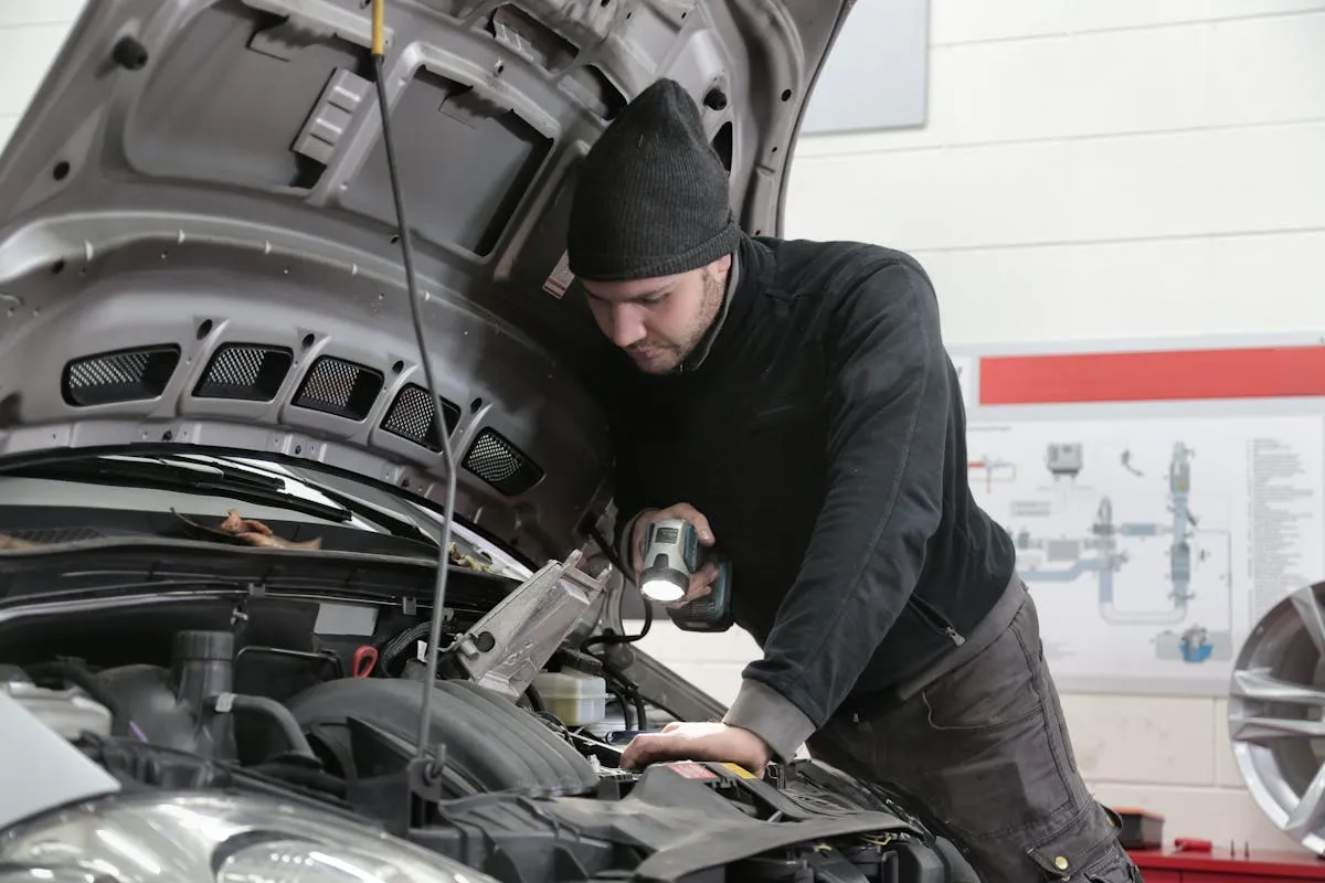 Mobile mechanic performing a pre-purchase vehicle inspection at a customer location